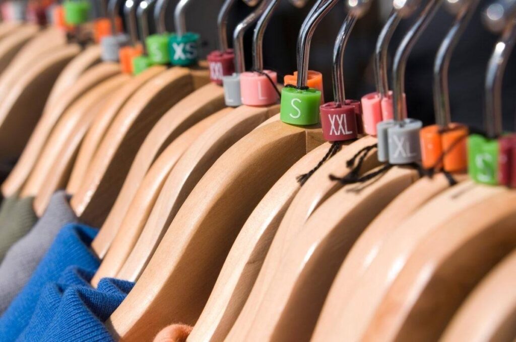 Wholesale clothing size tags on garment hangers in a retail fashion store