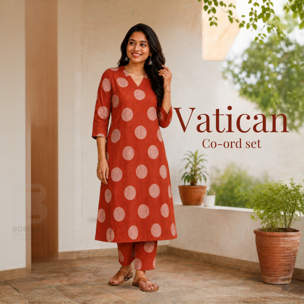 Woman wearing a Vatican co-ord set with a rust-orange polka dot kurta and matching pants from Bombay Collection, a trusted wholesale clothing supplier.